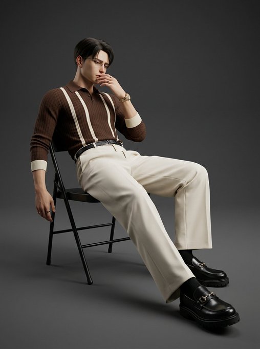 Fashion editorial photo of a male model sitting on a black folding chair, wearing a brown striped polo shirt, cream trousers, and chunky black loafers against a gray background.