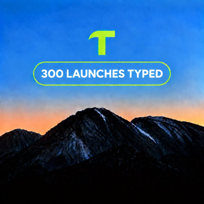 A promotional graphic with a mountain landscape at sunset featuring a green 'T' logo and a badge reading '300 LAUNCHES TYPED'.