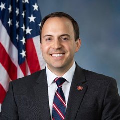 A U.S. Congressman, identified in the accompanying post as Lance Gooden, is shown smiling in an official portrait with an American flag in the background. The image supports the post's message highlighting his views on Bitcoin and AI as transformative forces in global power dynamics.