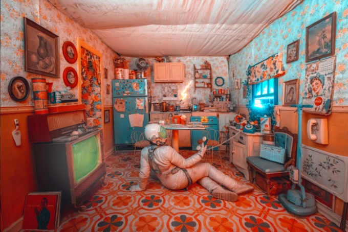 A nostalgic, highly detailed diorama of a vintage retro kitchen with floral wallpaper, a turquoise refrigerator and stove, and an astronaut figure sitting on the floral patterned floor.