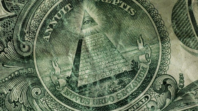 A close-up image of the US one-dollar bill featuring the "Eye of Providence" atop a pyramid, with "ANNUIT COEPTIS" and "NOVUS ORDO SECLORUM" visible.