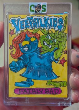 A hand holds a trading card in a clear plastic sleeve featuring the text "C&S," "VEGGIE KIDS," and "FAIRLY BAD," depicting a blue tomato-headed character and a green creature on a yellow background.