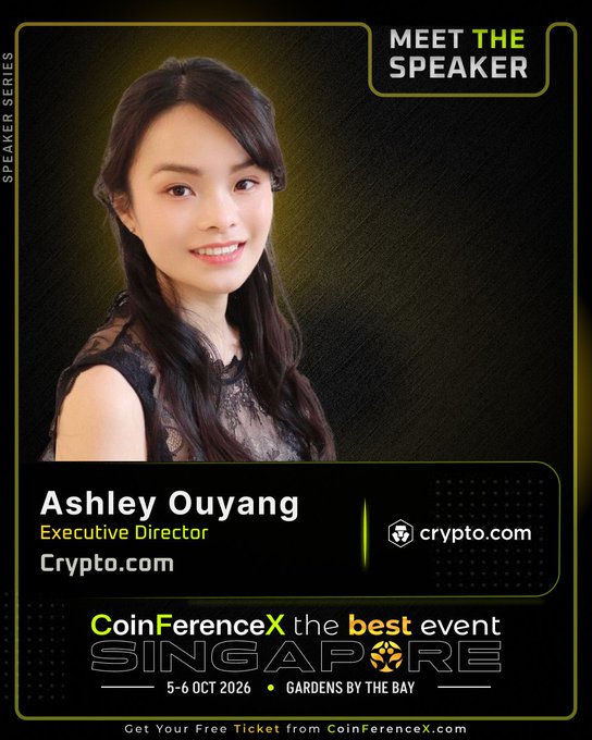 The poster for CoinFerenceX Singapore (5-6 OCT 2026 at Gardens by the Bay) features Ashley Ouyang, Executive Director at Crypto.com, announcing her as a speaker for the event. It directly supports the post by highlighting her role and affiliation with Crypto.com, aligning with the description of her expertise in derivatives and complex deal execution.