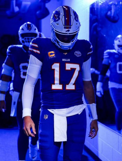 Buffalo Bills quarterback Josh Allen, wearing jersey number 17 with a captain's 'C' patch, walking through a tunnel in his blue uniform.