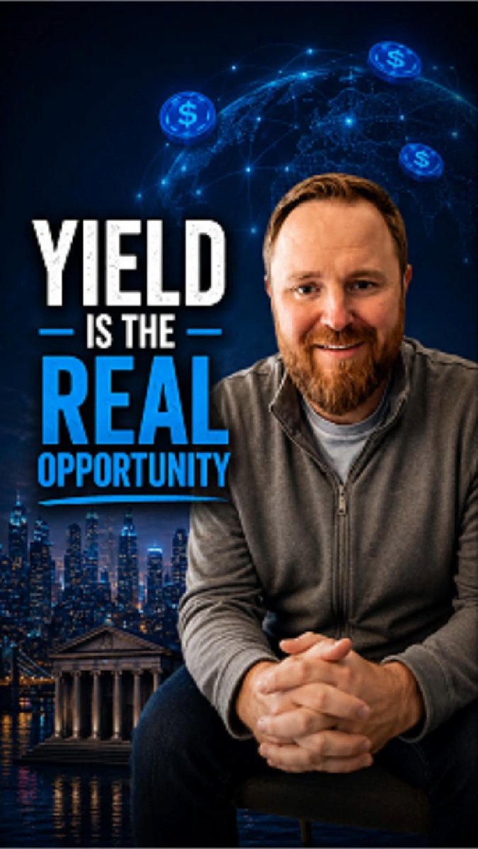 The image features a man sitting down with his hands crossed, wearing a gray jacket. The background shows an illustration of a city skyline at night, with buildings illuminated by lights. Below this scene, there are three blue circles floating around the man's head, which appear to be coins or tokens. The caption below the image reads "Yield is the real opportunity" and "Stablecoins Are Crypto’s Killer App".