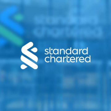 The image features a blue background with white text that says "Standard Chartered". Below this, there's an announcement about Bitcoin. Geoffrey Kendrick, who is a Standard Chartered analyst, is discussing Bitcoin's current market conditions. He mentions that Bitcoin has reached $59,000 and points to the SpaceX IPO and a potential U.S.-Iran peace deal as factors that might be driving up Bitcoin prices. The image seems to be in focus on these recent events.