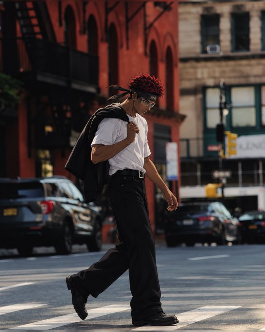 An anime-style illustration of a young man with red spiky hair and a black headband, wearing a white shirt and dark pants, crossing a city street with red brick buildings and parked cars in the background.