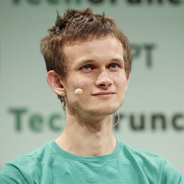 Portrait of Vitalik Buterin, Ethereum co-founder, speaking at a TechCrunch event wearing a green t-shirt and headset microphone.