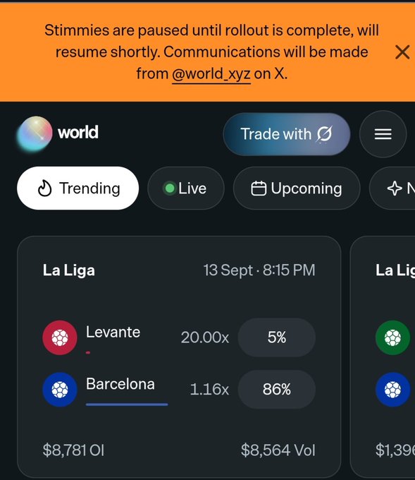A screenshot of a trading app called 'world' shows La Liga odds for Levante vs Barcelona, with a notification at the top stating 'Stimmies are paused until rollout is complete, will resume shortly. Communications will be made from @world_xyz on X.'