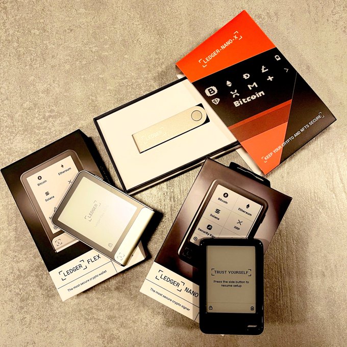 A collection of Ledger hardware wallets—including the Ledger Nano, Ledger Flex, and Nano Gen5—is displayed alongside their packaging, showcasing the trusted devices offered through the official Ledger program. The image reinforces the post's message about gifting Bitcoin ($BTC) rewards to new purchasers of eligible Ledger hardware wallets.