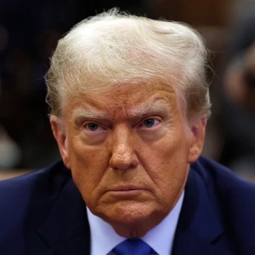 Former President Donald Trump is shown in a close-up portrait wearing a dark blue suit and tie, with a serious facial expression. The image relates to the post as it depicts Trump during his presidency, a period when his administration's economic policies—including tariffs and trade disputes—were significant factors influencing U.S. inflation trends and Federal Reserve rate decisions, making the upcoming CPI data particularly relevant.