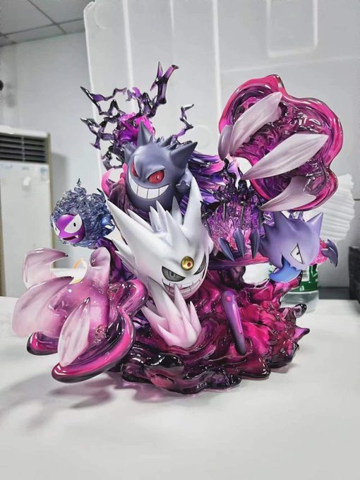 A dynamic Pokémon figurine featuring Gengar, Haunter, and Gastly is displayed on a desk, with the ghostly trio emerging from swirling purple energy effects. The post thanks "crypto" for the impressive collectible, suggesting the figure was a crypto-related reward or purchase.