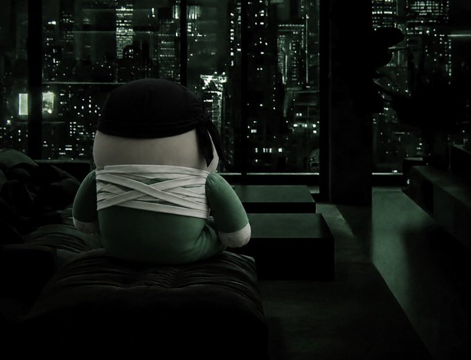A stuffed character, dressed as a ninja and bandaged, sits on a couch looking out at a city skyline at night, mirroring the sentiment of not missing a "sub 10m entry."