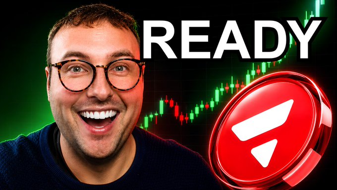 The image features a man wearing glasses, smiling, and holding up a red coin with a white triangle symbol on it. The background of the image has a green gradient that says "Ready" written in black letters above the coin. The text "AVAX IS GEARING UP FOR A MAJOR MOVE! COULD WE SELL $60 SOON? THESE ARE KEY LEVELS TO WATCH youtu.be/YTkb0U5BVOQ". This suggests that AVAX is a company preparing for a major move, and they are likely to sell shares at $60 soon.
