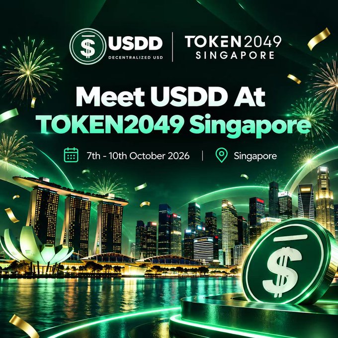 A promotional graphic for USDD's attendance at TOKEN2049 Singapore, dated 7th–10th October 2026, featuring a green-themed design with fireworks, the Singapore skyline (including Marina Bay Sands), and a large USDD coin. The image visually reinforces the announcement of USDD's participation at the TOKEN2049 crypto conference in Singapore.