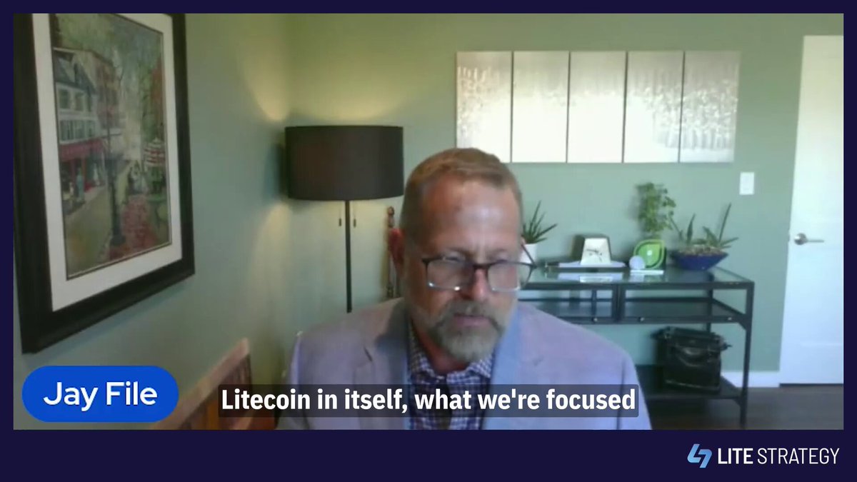 The image shows a man wearing glasses sitting at a desk in front of a computer screen. The text in the image reads "Litecoin in itself, what we're focused on, making sure both the asset and the ecosystem keep moving forward in sync." This suggests that the man is likely discussing or analyzing Litecoin's current state and future direction within the cryptocurrency market.