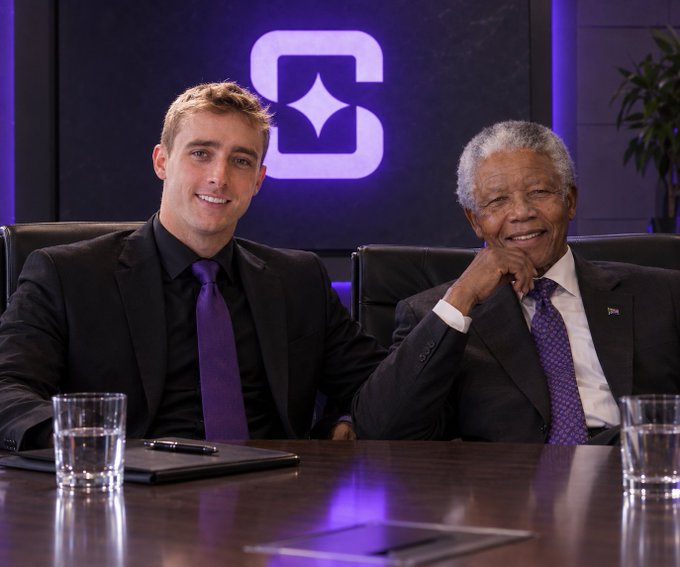 Two men in dark suits with purple ties sit smiling at a table with glasses of water, posing in front of a glowing purple logo featuring a star design. The post promotes a $100 appreciation giveaway for their "boss" Noah Dummett, inviting compliments about him in the comments.