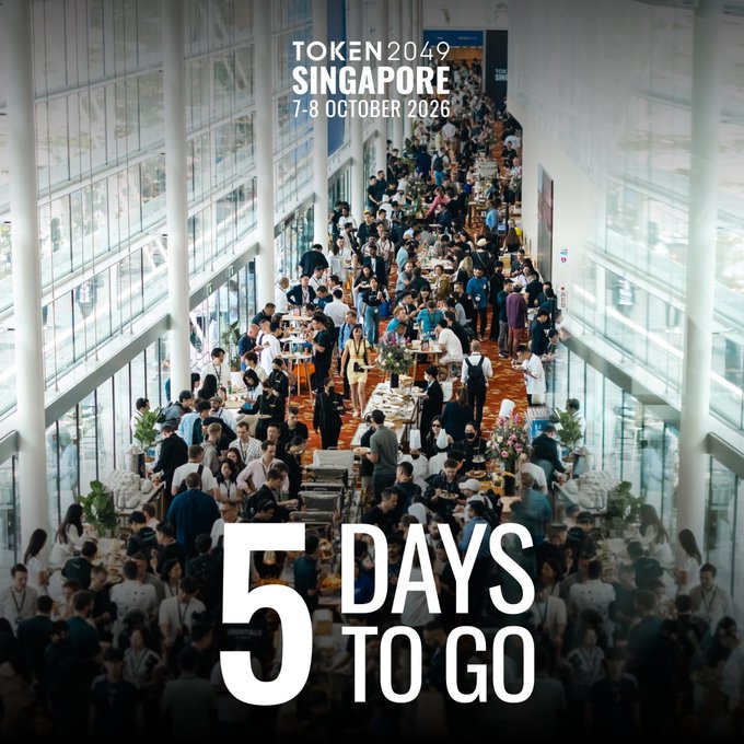 A promotional image for TOKEN2049 Singapore (7-8 October 2026) showing a large crowd at a previous event, with bold overlay text reading "5 DAYS TO GO." The image visually reinforces the post's countdown to the crypto conference returning to Marina Bay Sands next week.