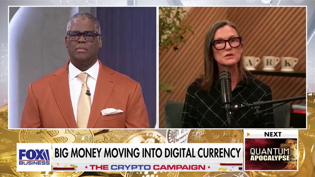 The image shows two men speaking at a political event, with one man wearing an orange suit and tie and another holding a microphone. The backdrop features a building labeled "FOX", indicating that this may be a media or broadcasting event related to politics. On the left side of the frame, there is text that reads "#BITCOIN IS GOING TO $1,250,000 #THE BIGGEST REASON IS INSTITUTIONAL ADOPT".