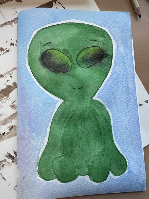 A watercolor painting of a green alien-like figure with large black eyes and a small smile, set against a light blue background.