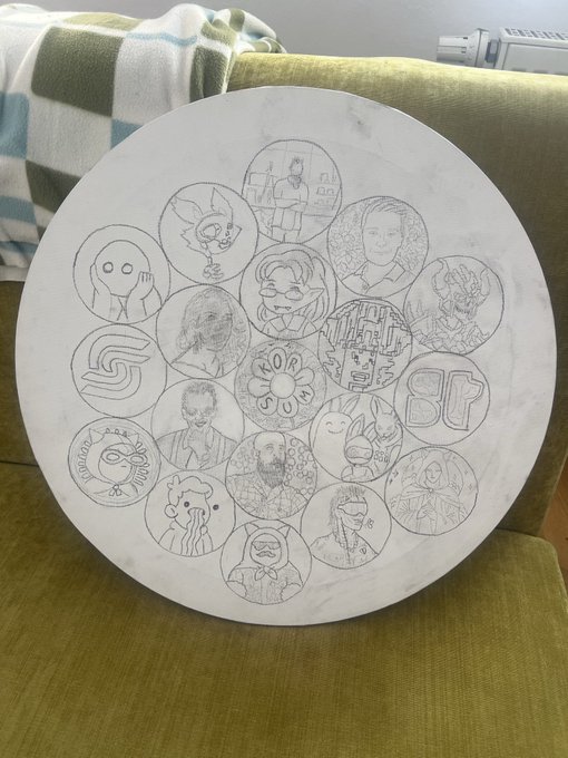 A round marble tray resting on an olive-green couch features 15 hand-drawn sketches in circular frames, including characters, portraits, a ghost, and a doodle-like figure with "BT" lettering. The accompanying post notes this is Day 2 of the project, with sketching complete and coloring set to begin next.