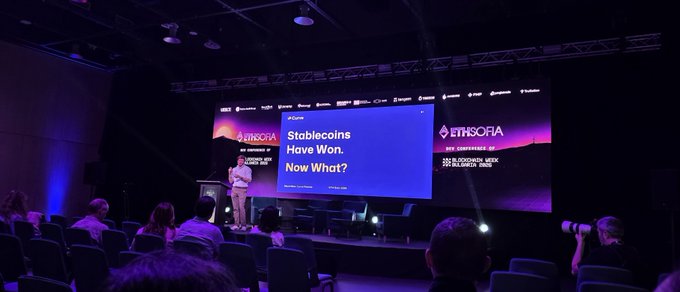 A wide shot of a conference stage at ETHSofia where a presentation slide titled 'Stablecoins Have Won. Now What?' is displayed on large screens before an audience.