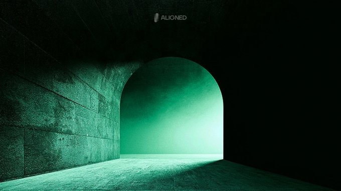 A moody green-lit arched tunnel or corridor with the text 'ALIGNED' displayed in the upper center of the dark concrete wall.
