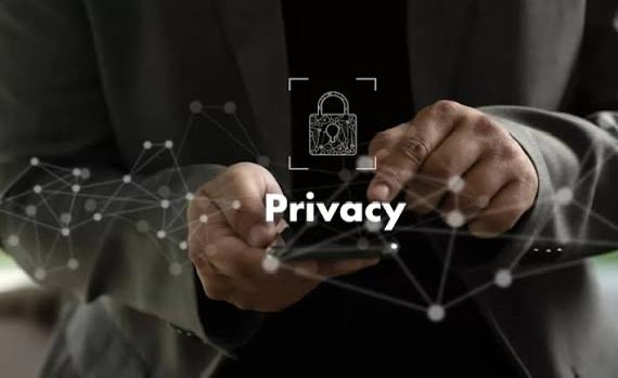 A conceptual image showing a person in a suit using a smartphone, overlaid with a digital network graphic and a central padlock icon with the word 'Privacy' emphasizing data security.