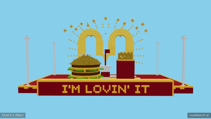 The image features a large, colorful cartoon hamburger with a golden bun sitting atop a red platform. Below the hamburger, there's a sign that reads "I'm Loving It". The background of the image is blue, which contrasts nicely with the vibrant colors and shapes in the foreground. In the bottom right corner of the image, there's a watermark that says "GLM-5.2 too!".