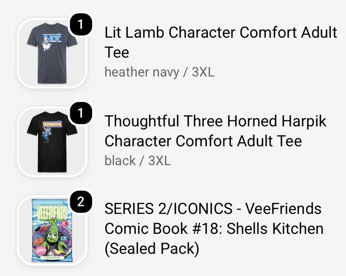 An online shopping cart displays three items: a 'Lit Lamb Character Comfort Adult Tee' in heather navy (3XL), a 'Thoughtful Three Horned Harpik Character Comfort Adult Tee' in black (3XL), and a 'SERIES 2/ICONICS - VeeFriends Comic Book #18: Shells Kitchen (Sealed Pack)'.