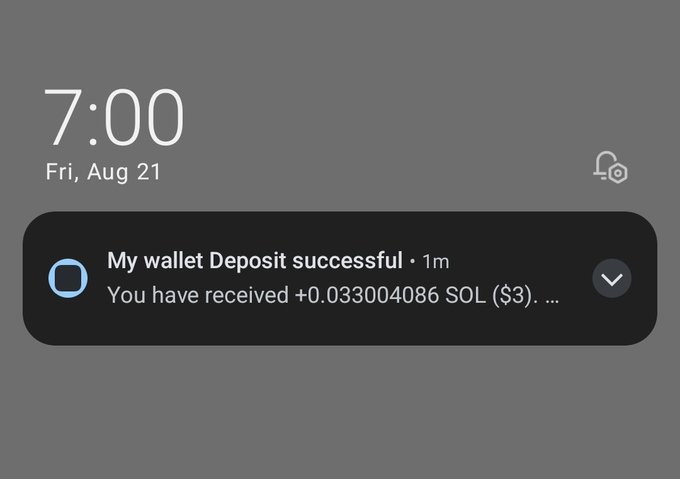 A smartphone lock screen notification at 7:00 on Friday, August 21, displaying a wallet deposit success message for +0.033004086 SOL ($3...).