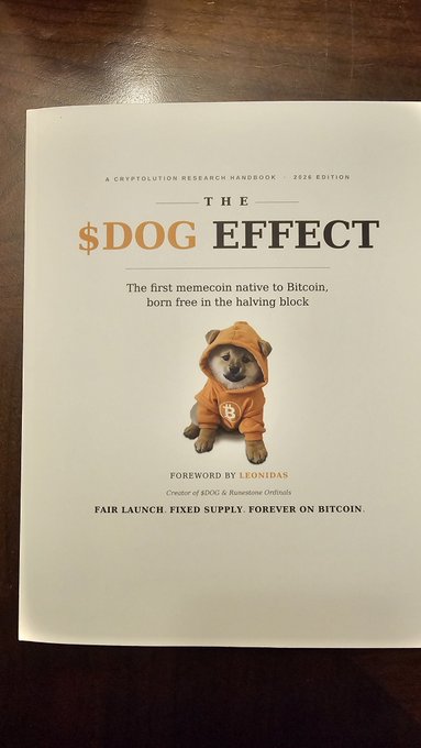 A book cover titled "THE $DOG EFFECT" subtitled "A CRYPTOLUTION RESEARCH HANDBOOK 2024 EDITION" featuring a Shiba Inu dog wearing a hoodie, with foreword by Leonidas.