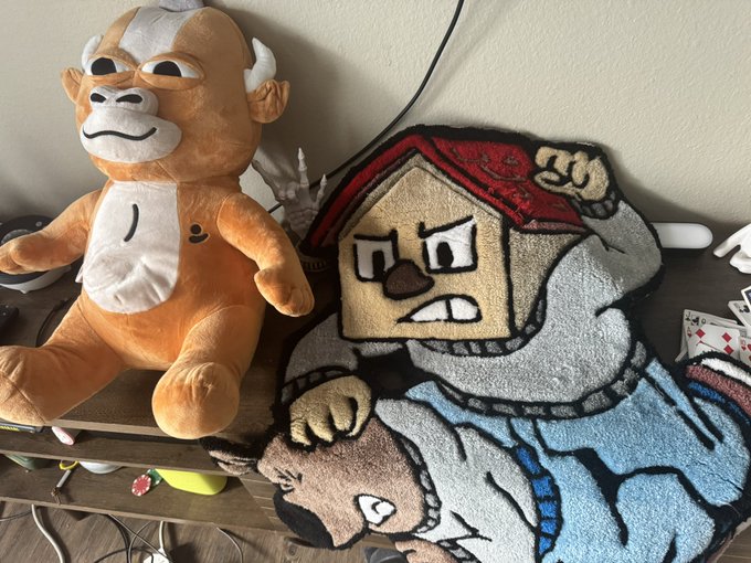 A plush Donkey Kong toy sits beside a custom rug depicting a rug-pulled cartoon character, visually referencing the crypto slang "rugged" — meaning a project abandoned by its developers after investors bought in. The post's mention of being "rugged by @ChillHouseSOL" pairs with the imagery to humorously illustrate the disappointment of a failed Solana NFT/token project.