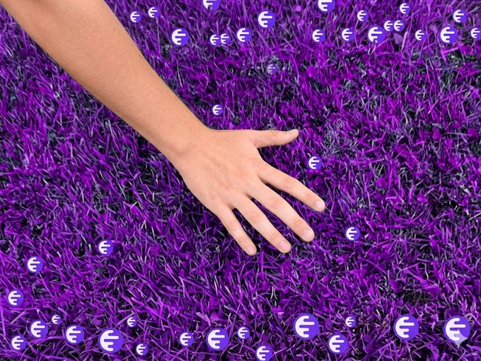 ""Go touch some grass" $INK". This phrase is a command for someone to physically interact with the purple carpet by touching it, as if they were trying to "touch something." The image also includes a hand reaching out towards the carpet, further emphasizing this instruction.