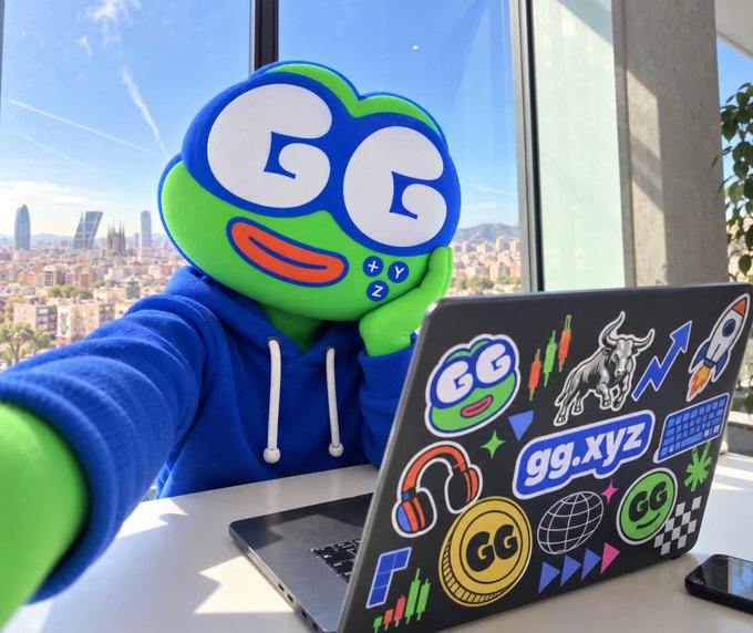 A promotional image showing a green GG mascot character wearing a blue hoodie, sitting at a desk with a laptop covered in gg.xyz stickers, with a cityscape visible through the window behind.