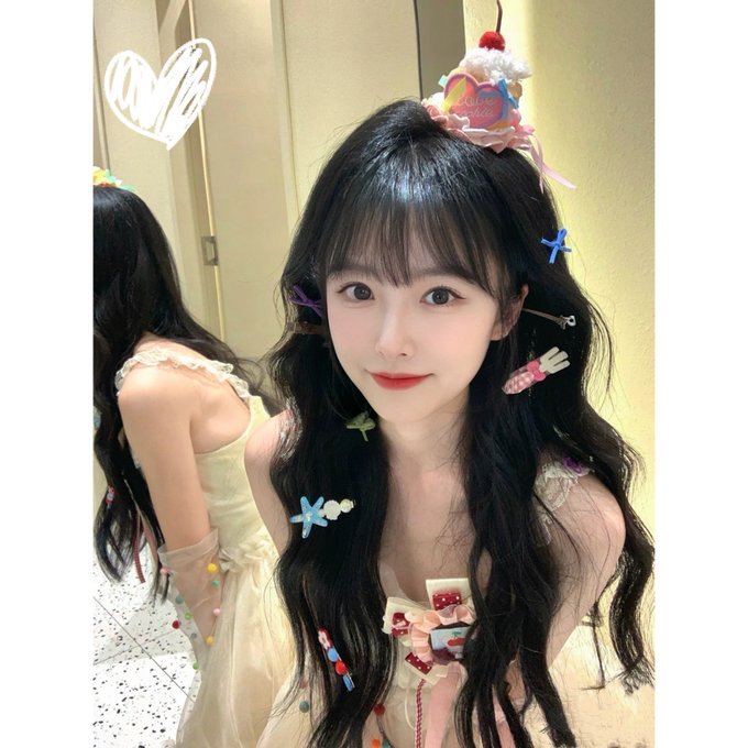 The image features a woman with long black hair wearing a dress, which has various decorations such as tiaras and other accessories. The woman appears to be posing for a picture or participating in an event related to River Pts, as suggested by the caption "$RIVER staking 官方提过 两种收益口径". This implies that the woman is involved in some sort of promotional activity or celebration for River Pts. The image also includes a heart and a cupcake, which could be related to the event's theme or decorations.