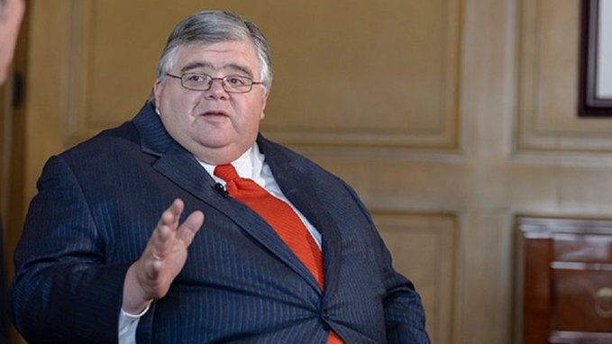 The image shows a heavyset man in a dark suit and red tie, gesturing while speaking in what appears to be a wood-paneled room, likely a TV interview setting. This appears to be a financial commentator or analyst discussing the market's potential breakout, though no text or ticker symbols are visible in the image itself.