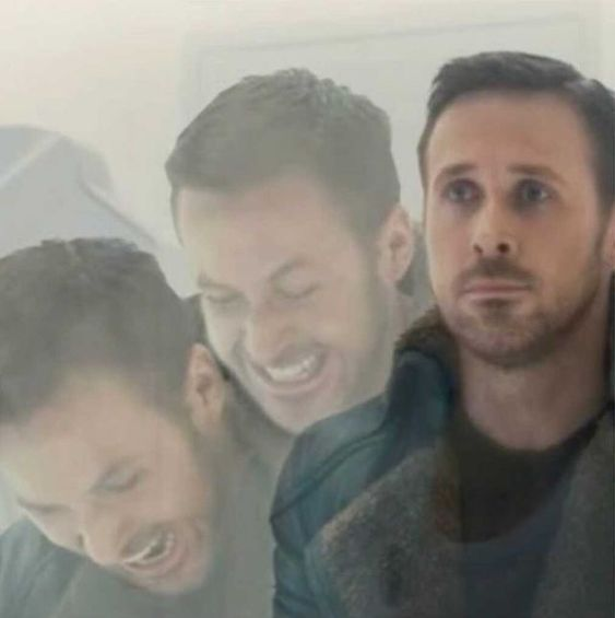 Three men, including one with a beard wearing a dark hoodie, appear in a hazy or smoke-filled scene, with two of them laughing while the third looks on seriously.