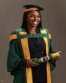 The image features a woman wearing a green graduation gown with yellow accents, standing against a gray background. She has her arms crossed over her chest and is smiling at the camera. The caption below the photo reads "B.TECH BAGGED Now let's bag some BTC". This suggests that she might be promoting or discussing a product related to technology or education in the context of the graduation ceremony.