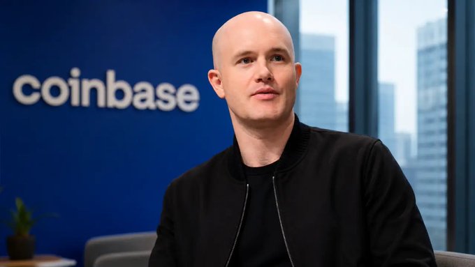 Coinbase CEO Brian Armstrong is shown in a professional setting with the company's logo displayed on a blue wall behind him. The image accompanies news that Coinbase ($COIN) has received CFTC approval to launch its own U.S. crypto derivatives clearinghouse, marking a major regulatory milestone for the cryptocurrency exchange.