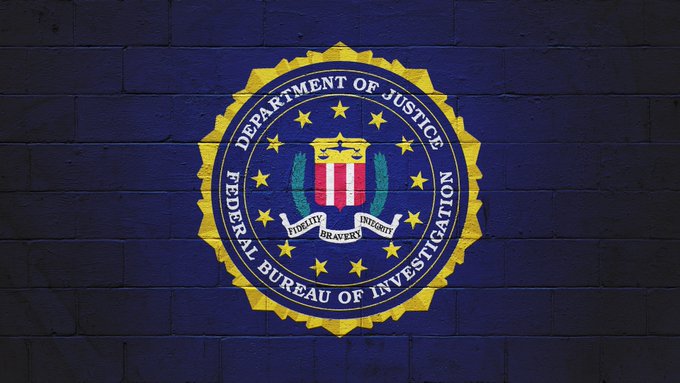 The FBI seal is displayed on a brick wall, representing the agency's successful execution of "Operation Blackout," which dismantled a major international crypto fraud network and led to the seizure of over $15 billion in stolen digital assets—one of the largest crypto enforcement actions in history.