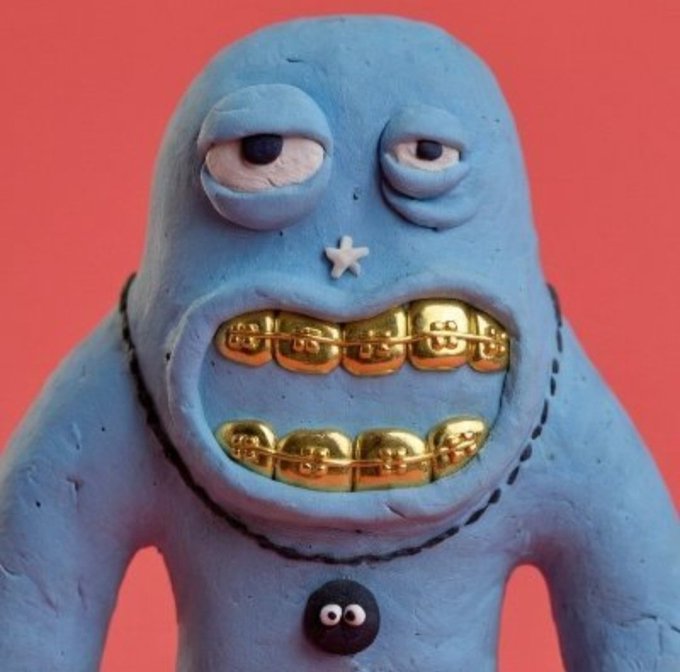A blue clay-like cartoon monster figure with gold "just t00ns" grillz smiles against a coral-red background, directly representing the giveaway for the "just t00ns" NFT collection featured in the post.