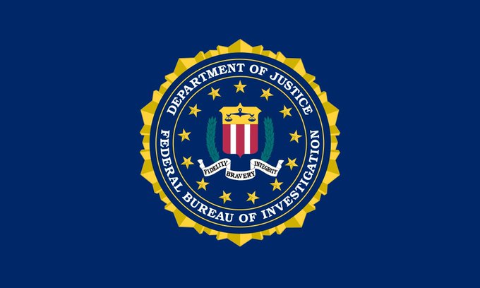 The image shows a close-up view of the logo for the Federal Bureau of Investigation (FBI), which is displayed against a blue background with white text. The logo includes a shield featuring a coat of arms, symbolizing strength and authority. Below the logo, there is text that reads "DEPARTMENT OF JUDICIARY FBI BUREAU OF INFOREST" and "FEDERAL BUSINESS INVESTIGATION". This image may have been used in a post related to the recent seizure of assets worth approximately $127,000,000. The phrase "THE FEDERECY'S DECADE OF THE BIGGEST SEIZURE IN US HISTORY" suggests that this event was a significant moment in US history involving the FBI and its involvement in high-profile cases such as Operation Blackout.