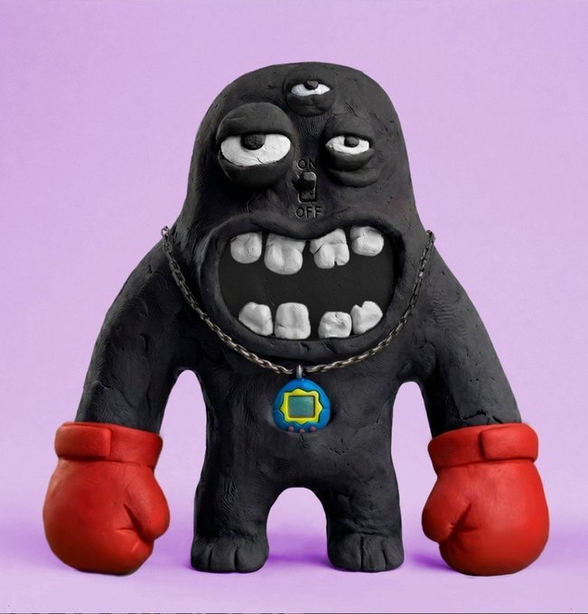 A claymation-style figure of a black, three-eyed monster with a wide toothy grin, red boxing gloves, and a chain necklace with a small Tamagotchi-style device pendant, set against a pink background.