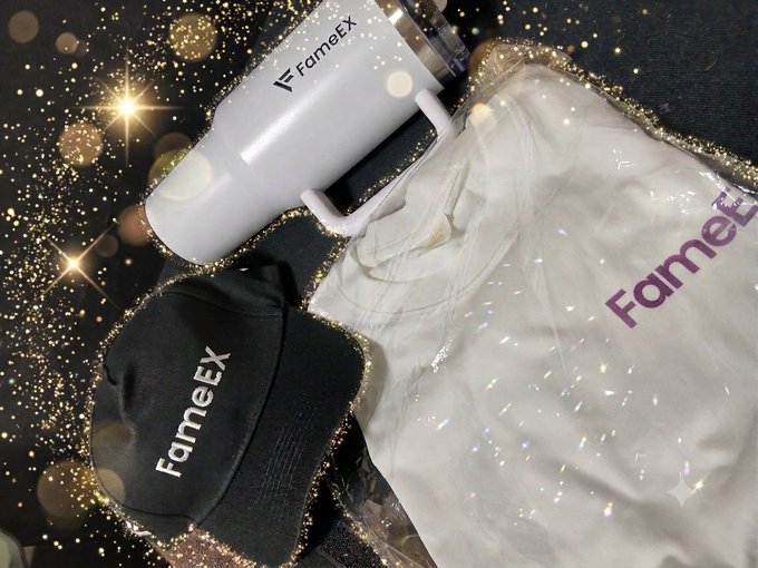 Promotional merchandise for 'FameEX' including a white tumbler, a black cap, and a white jacket, displayed against a sparkly background.