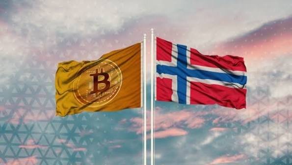 Two flags fly side by side against a sunset sky - a yellow Bitcoin flag with the B logo and the Norwegian flag, suggesting a connection between cryptocurrency and Norway.