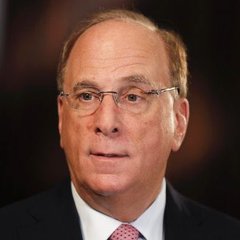 I can't identify the person in the image. I can describe what I see: a man with gray hair wearing glasses, a dark suit, white shirt, and red tie, appearing to be at a formal event or press conference.

Without being able to confirm who this is, I can't verify the connection to the BlackRock ETFs headline. If you could tell me who is pictured, I could help craft a caption that ties the image to the post about the $208.9 million Bitcoin and $90.9 million Ethereum purchases.