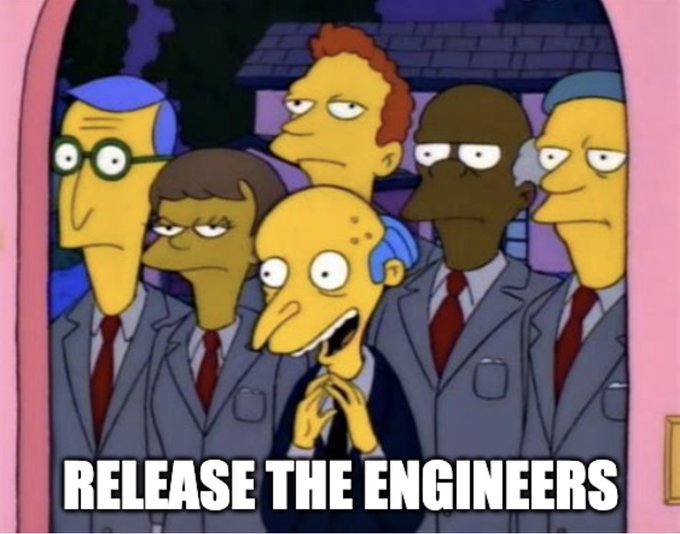 The image features a group of cartoon characters, including a man with a big smile wearing a suit and tie, who appears to be an engineer or scientist. The text "Release the engineers" is written below him, suggesting that he has just made a significant discovery or invention related to engineering.
