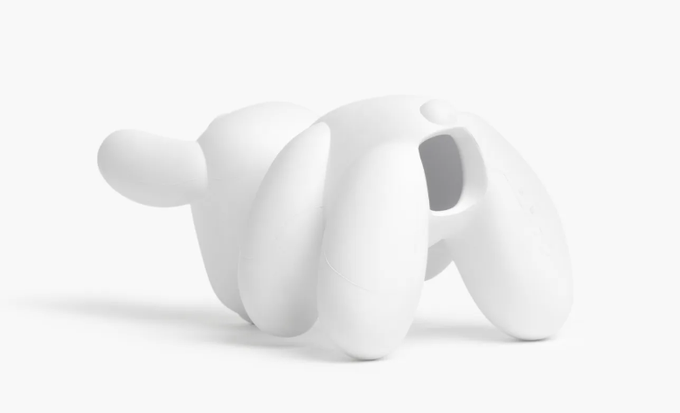A glossy white sculptural figure with exaggerated, oversized limbs and a hollowed-out torso sits against a minimal background, evoking the abstract, cartoonish charm associated with meme-inspired crypto characters. Its featureless, balloon-like form visually echoes the playful, quirky aesthetic of dog-themed tokens like DOGE, FLOKI, and SPARKY.