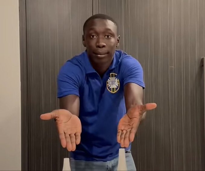 A man wearing a blue polo shirt with a "BU" emblem stands with his palms up and arms outstretched in a shrugging gesture, appearing to ask a question or express disbelief, which complements the post's message about not being persuaded by a mere $10.